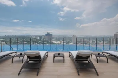 a balcony with chairs and a view of the city at Citadines Benavidez Makati in Manila