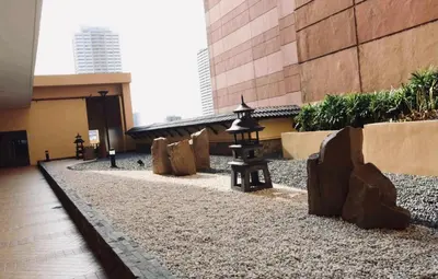 a building with a courtyard with a group of lanterns at Simple & Cozy 1 Bedroom US Embassy, Roxas Blvd, Ermita, Manila in Manila
