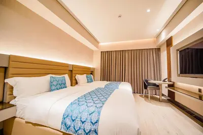 a hotel room with a bed and a television at Bayprime Hotel in Manila