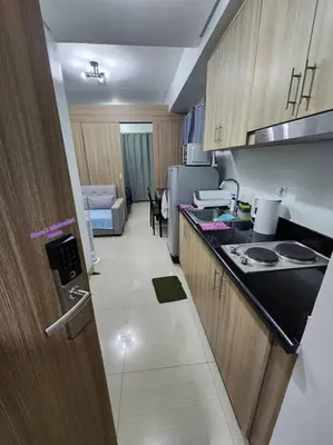 a kitchen with a sink and a counter top at SMDC Shore 2 Minimalist Home in Manila