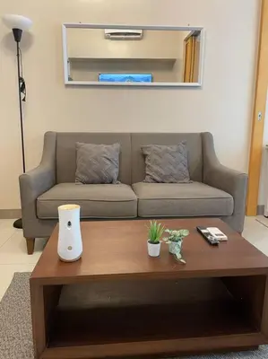 a living room with a couch and a coffee table at Cozy 1 BR One Uptown Residences BGC in Manila
