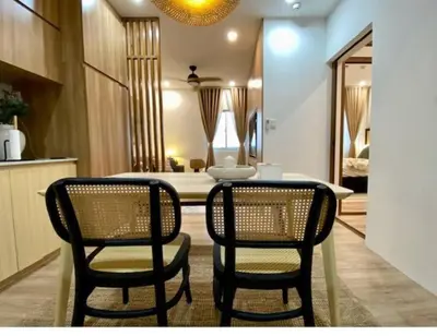 a dining room with two chairs and a table at Nuvali Laguna Amaia 2BR free parking @ The Sanctuary near Tagaytay and Carmelray Industrial Park in Numero Dos
