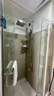 a shower in a bathroom with a glass door at Mall of Asia Shore 2 Condo in Manila