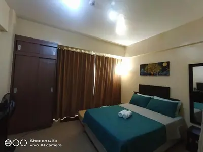 a bedroom with a bed with a stuffed animal on it at Pasay Condotel near NAIA terminal 3 (3 mins walk in) in Manila