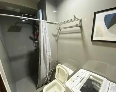 a small bathroom with a toilet and a mirror at Air Residences with Fast Wifi in Manila