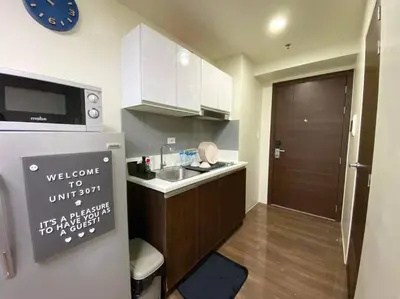 a small kitchen with a sink and a microwave at Air Residences with Fast Wifi in Manila