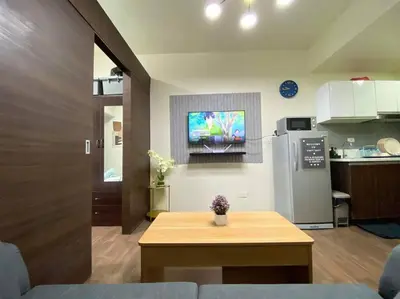 a kitchen with a table and a refrigerator at Air Residences with Fast Wifi in Manila