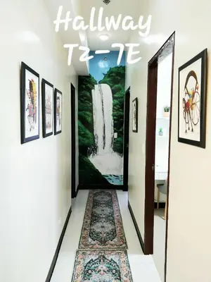 a hallway with an open door with a rug at The Florence Condo McKinley Hill in Manila