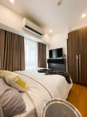 a bedroom with a large white bed and a window at The Milano Residences in Manila