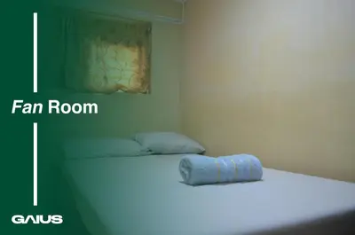 a room with a bed with a blue towel on it at Gaius Inn in Manila