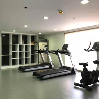 a gym with three tread machines in a room at Staycation by JAR - Condo Unit in Manila