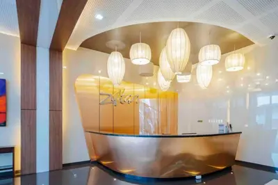 a lobby with several chandeliers and a table in a room at Staycation by JAR - Condo Unit in Manila