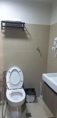 a bathroom with a white toilet and a sink at Jejo Suite Home Shore 3 Residences Staycation 1 BR Unit Near MOA with Netflix and Prime Video in Manila