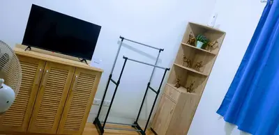 a flat screen tv on a stand in a room at Hantowah's Crib - Southwoods in San Pedro