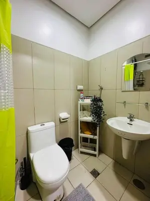 a bathroom with a toilet and a sink at Night Blink Staycation and Rentals in Manila
