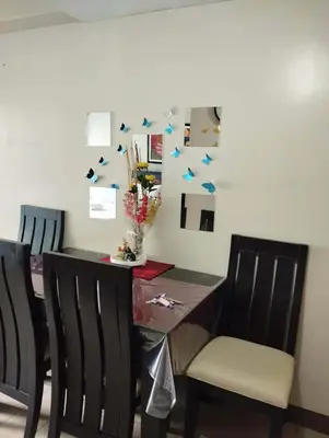 a dining room table and chairs with blue stars on the wall at One Palm and Two Palm Tree Villas in Manila