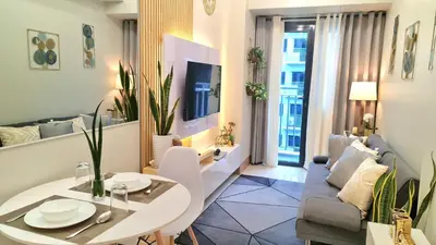 a living room with a table and a couch at Blissful Haven Suite Staycation Pasay Metro Manila near SM Mall of Asia Naia Airport Okada in Manila