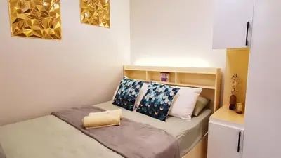 a small bedroom with a bed with a book on it at Blissful Haven Suite Staycation Pasay Metro Manila near SM Mall of Asia Naia Airport Okada in Manila
