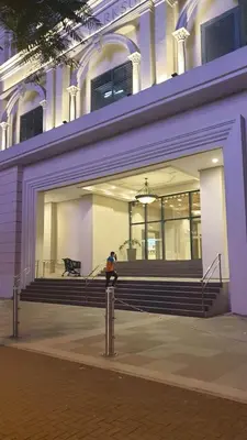 a person standing in front of a building with stairs at Uptown Parksuites BGC in Manila