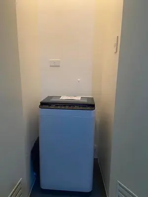 a small refrigerator with a blue light on top of it at Prisma Residences - Celeste Bldg in Manila