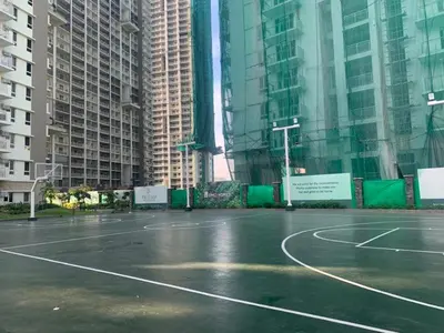 a basketball court in a city with tall buildings at Prisma Residences - Celeste Bldg in Manila