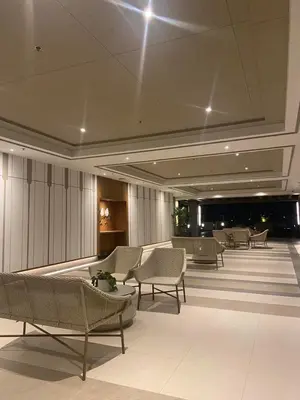 a lobby with chairs and tables in a building at Prisma Residences - Celeste Bldg in Manila