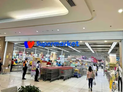 a store with people walking in a shopping mall at ClaySky Staycation Cozy Modern 1BR unit near MOA with Netflix & HBO Max in Manila