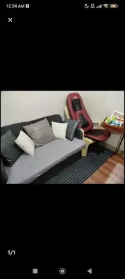 a couch with pillows and a chair in a room at 2-BR COZY condo 200mbpsFiberWiFi/Netflix/pool/WFH in Manila