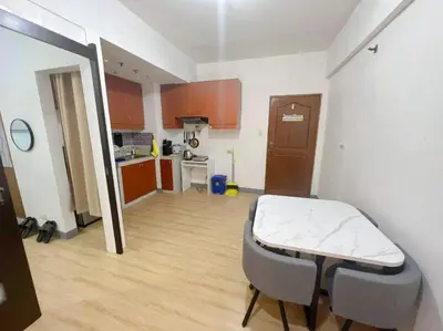 a small room with a bed and a kitchen at One Bedroom condo Unit in Eastwood Libis . Fast free wifi /netflix in Manila
