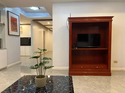 a living room with a television and a potted plant at My Suite Heart of San Juan City near Greenhills, Ortigas with Roof Garden in Manila