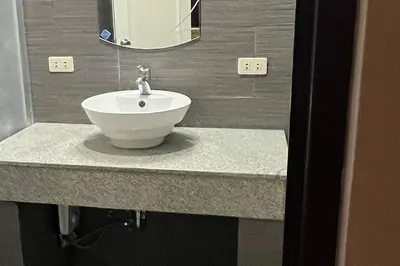 a bathroom with a white sink and a mirror at My Suite Heart of San Juan City near Greenhills, Ortigas with Roof Garden in Manila