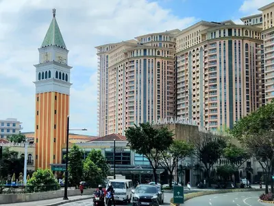 a clock tower in a city with tall buildings at 12e Spacious Cozy Suite at The Venice Mall with FREE Parking and Washing Machine in Manila