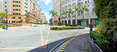 a person walking down a street in a city at Condotels Near Terminal 3 Airport in Manila