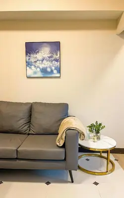 a living room with a couch and a table at Cityscape View 2BR in Uptown BGC w 200mbps WiFi in Manila