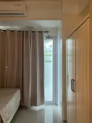 a bedroom with a bed and a sliding glass door at SMDC Jazz Residences Makati City Philippines in Manila