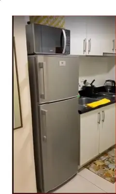 a kitchen with a stainless steel refrigerator and a sink at SMDC Jazz Residences Makati City Philippines in Manila