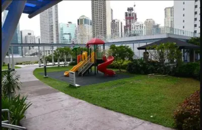 a playground with a slide in a park in a city at SMDC Jazz Residences Makati City Philippines in Manila