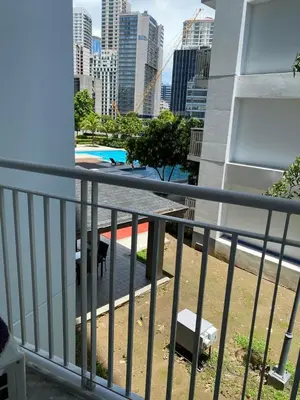 a dog standing on the balcony of a building at SMDC Jazz Residences Makati City Philippines in Manila