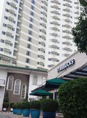 a large white apartment building with a hotel at Lovely 1 bedroom at Vista Shaw Residences in Manila