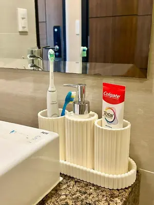 a bathroom with a toothbrush and tooth paste and a sink at BGC, Luxe McKinley Condo at Venice Residences, Free Parking and WiFi in Manila