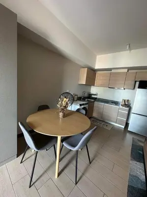 a dining room table and chairs in a kitchen at BGC, Luxe McKinley Condo at Venice Residences, Free Parking and WiFi in Manila