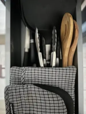 a counter with wooden utensils and knives in a kitchen at BGC, Luxe McKinley Condo at Venice Residences, Free Parking and WiFi in Manila