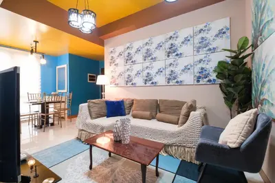 a living room with a couch and a table at Family Staycation, Greenbelt Hamilton, Isabel's Makati Rooms in Manila
