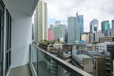a balcony with a view of a city skyline at Family Staycation, Greenbelt Hamilton, Isabel's Makati Rooms in Manila