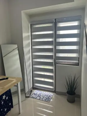 a room with a window with shutters on it at Cozyhome by LV & SG - S residences MOA PASAY unit condo in Manila