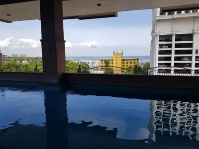 a swimming pool with a view of a building at Hospital ng Manila front delux le mirage de malate in Manila