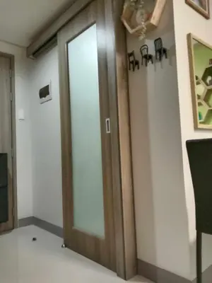 a wooden door in a room with a wall at OASIS CHIC By THE BAY PASAY CITY Near Mall of Asia in Manila