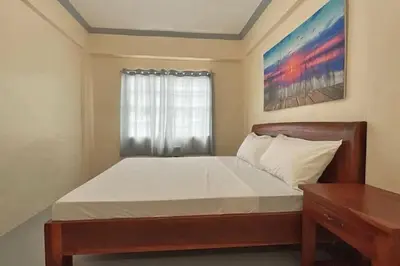 a bedroom with a large bed with a window at Lawton Residences Studio Room 2F in Manila