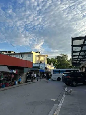 a group of people and a bus on a street at Lawton Residences Studio Room 2F in Manila