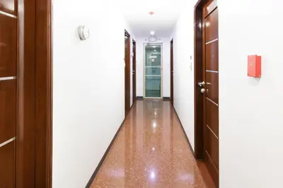 a hallway with two doors and a floor with wood floors at Starlight Bed and Breakfast in Manila